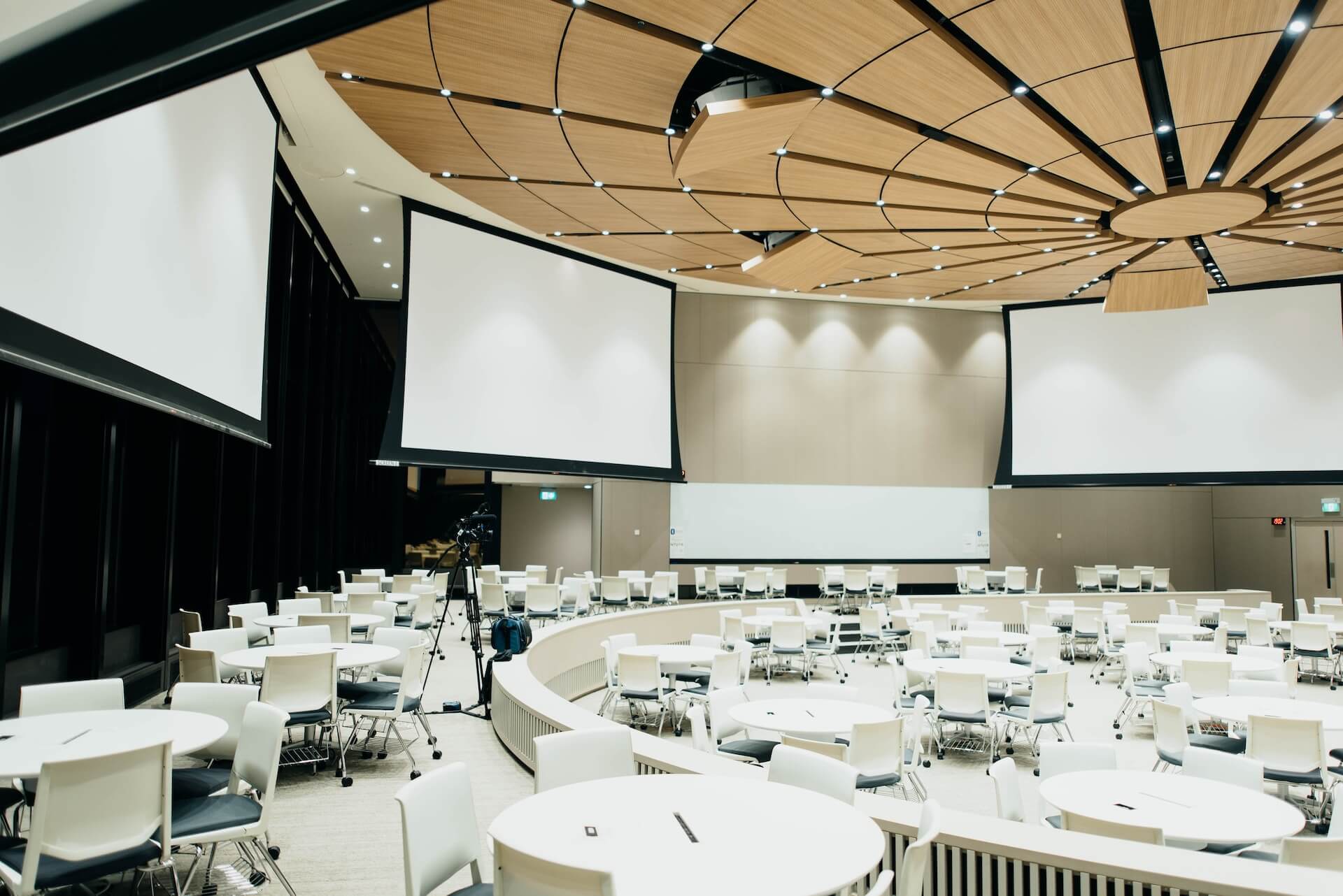 Inside a of a large conference room with tables and chairs